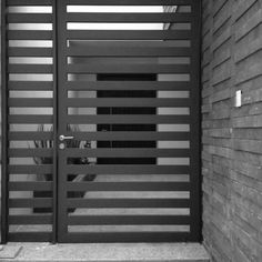 a black and white photo of an entrance to a building with metal bars on it