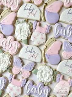 baby shower cookies are arranged on a table