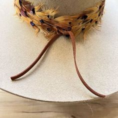 The Stellar Western Feather Hat Band, measuring 3 cm in width and approximately 58 cm in length (excluding the leather ties), offers a refined touch to any hat. Designed to fit most, it features adjustable leather ties for a secure and comfortable fit. The center crown, measuring 2.5" W x 2.25" H, adds a distinctive element, while the feather detailing brings a touch of rustic charm, making this hat band a stellar addition to any western-inspired wardrobe. Feather Hat Band, Cowboy Hat Band, Cowboy Hat Bands, Black Iridescent, Clothes Steamer, Western Accessories, Feather Hat, Pets For Sale, Cowboy Boots Women