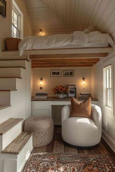 a bedroom with a loft bed above it and stairs leading up to the second floor