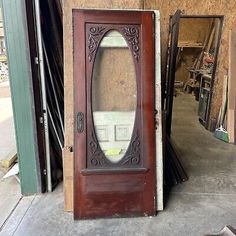 an old wooden door with a mirror on the front and side doors in different sizes