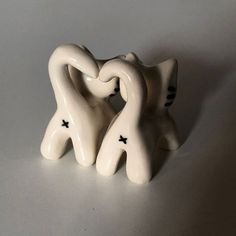 two white ceramic figurines sitting next to each other