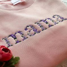 Celebrate the special woman in your life with our Custom Embroidered Mama Grandma Floral T-Shirt Sweatshirt Hoodie. This exquisite piece is not just a garment; it's a token of appreciation for every mother and grandmother. Each sweatshirt is delicately embroidered with a word, adorned in a stunning floral design. Available in a variety of floral color options, this hoodie is designed to provide both comfort and style. Specifications: Material: High-quality cotton blend for softness and durabilit Mother's Day T-shirt, Hooded Cotton Tops With Embroidered Graphics, Cotton Hooded Sweatshirt For Mother's Day, Pink Cotton Hoodie With Letter Embroidery, Mother's Day Embroidered Crew Neck Sweatshirt, Mother's Day Embroidered Cotton Sweatshirt, Pink Hooded Tops With Custom Embroidery, Spring Hooded Top With Embroidered Logo, Cotton Tops With Letter Embroidery For Mother's Day