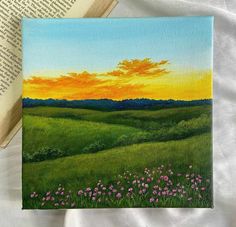 a painting of a sunset over a green field with wildflowers in the foreground