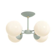 three white balls are attached to the ceiling light fixture in this modern - style chandelier