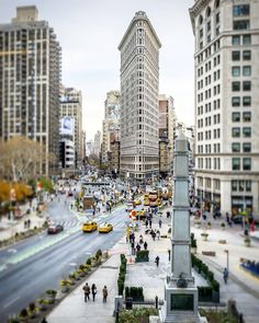 a city street filled with lots of traffic and tall buildings on either side of it