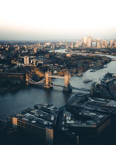 an aerial view of london with the river thames and tower bridge in the foreground