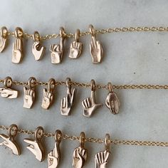 Buy in 14K Gold. A dainty, wearable version of the ASL (American Sign Language) Alphabet. If you'd like the donation portion of this purchase to go to Deaf Focus, please choose "Deaf Focus" on the pull-down menu at checkout! "Deaf Focus is a non-profit agency helping to make a difference with and for the deaf, deafblind, and hard of hearing (DDBHH) community!" Shop MIMOSA's ASL Jewelry Collection. How our ASL Jewelry came to be: I originally made custom ASL-inspired jewelry for my long-time cust American Sign Language Alphabet, Sign Language Letters, Sign Language Alphabet, American Sign Language, Letter Charm, Inspired Jewelry, Letter Charms, Sign Language, The Alphabet