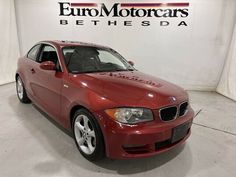 a red car is parked in front of the euro motorcars bethesda sign