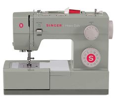 the singer heavy duty sewing machine is grey with red lettering on it's side