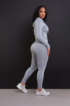 94% Polyester, 6% Spandex | Inseam: 26" Pre-Stretch | Model Wearing A Size L/XL | Runs True To Size You're just out here vibing as always, so kick back with this stylish set featuring a long sleeve zippered jacket with attached hood and front pockets at the waist and matching high-rise seamless leggings. Gray Elastane Activewear For Loungewear, Stretch Athleisure Tracksuit For Loungewear, Stretch Sportswear Sets For Jogging, Fitted Tracksuit For Jogging, Fitted Solid Tracksuit For Gym, Fitted Solid Tracksuit For Jogging, Gray Stretch Activewear For Loungewear, Sportswear Tracksuit With Stretch For Workout, Moisture-wicking Stretch Athleisure Set