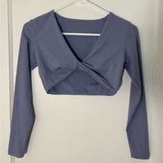 Never Worn Long-Sleeved Crop Top Workout Shirt With A Deep V Twist In The Front. Very Cute Top And Fits True To Size. Color Is Grayish Purple. Size | Xs Material | 75% Nylon, 25% Spandex Care | Hand Wash Only Stretch V-neck Crop Top For Workout, V-neck Stretch Elastane Crop Top, Long Sleeve Moisture-wicking Crop Top For Yoga, Fitted V-neck Purple Crop Top, Affordable Purple V-neck Crop Top, Crop Top Workout, Cute Top, Long Sleeve Crop, Deep V