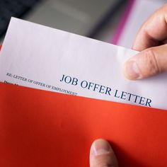 a person is holding a job offer letter