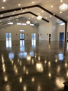 an empty room with chandeliers and lights on the ceiling is pictured in this image