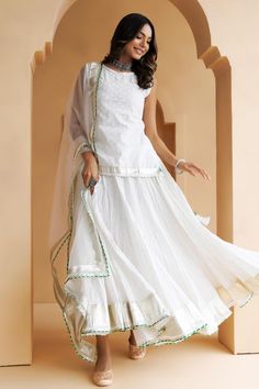 White skirt with gota lappa, magzi embellished borders. Paired with embroidered short kurta and dupatta.
Components: 3
Pattern: Embellished
Type Of Work: Gota lappa, magzi
Neckline: Round
Sleeve Type: Sleeveless
Fabric: Kurta and Skirt: Cotton, Dupatta: Organza
Color: White
Other Details: 
Border embroidered dupatta
Length:
Kurta: 25 inches
Skirt: 36 inches
Dupatta: 2.25 mtrs
Approx. product weight: 300 gms
Disclaimer: Since these products are handcrafted and hand dyed, hence may have slight irr White Palazzo Set With Dori Work For Wedding, White Anarkali Style Sleeveless Sharara, White Sleeveless Anarkali Sharara, Bohemian Fitted Sharara With Gota Work, Fitted Bohemian Sharara With Gota Work, Bohemian White Palazzo Set With Dupatta, Fitted White Palazzo Set For Transitional Season, White Fitted Palazzo Set For Transitional Season, White Anarkali Palazzo Set With Dori Work