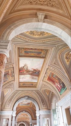 an ornate building with paintings on the ceiling