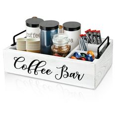 a coffee bar tray with cups, candy and candies in it on a white background