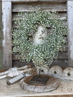 an olive wreath on top of a wooden table