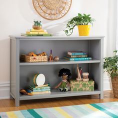 a shelf with books and toys on top of it