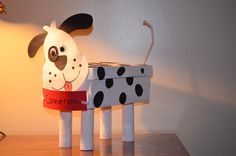 a lamp that is on top of a table with a dalmatian dog in front of it