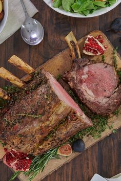 a large piece of meat sitting on top of a cutting board next to other food