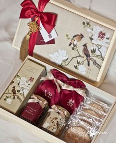 an open gift box containing teas and cookies