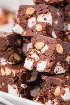 a pile of brownies with marshmallows and chocolate on top in a white bowl