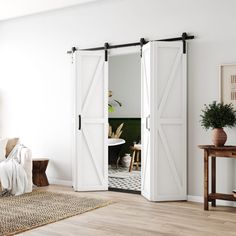 a living room with white walls and sliding doors