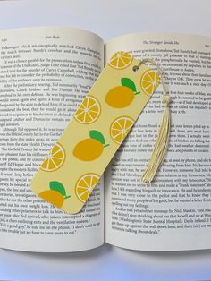 an open book with lemons on it and a tassel hanging from the cover