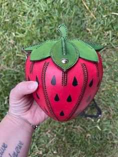 This is a very nice decorative leather Strawberry purse/ bag, all top grain Leather, Hand dyed red and green with black seeds, All handmade and stitched, opens from the top, has a twist closing or Magnetic clasp, Adjustable Strap with buckle 49'' to 56" in length (message me if you want a shorter strap for smaller/younger person). The purse measures approx. 8 inches from the top to the bottom and approx. 6.5 inches wide. the top has a opening of 4 inches wide x 3.5 inches and the purse is approx.6.5 inches deep tapered down to the point of the Strawberry, 3-D rounded Strawberry.  Perfect for a cell phone, card wallet and keys.  Want to convert your Crossbody bag into a Mini Backpack? Follow this link to Pintrest: https://pin.it/Jr87wMMgv Colors may vary slightly due to Picture quality and Red Shoulder Bag With Card Slots, Red Leather Clutch Coin Purse, Handmade Red Pouch Wallets, Handmade Red Clutch Wallet, Red Leather Pouch Coin Purse, Green Leather Coin Purse Pouch, Red Leather Coin Purse With Removable Pouch, Handmade Leather Coin Purse Clutch, Handmade Leather Clutch Coin Purse