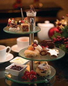 three tiered trays filled with pastries and desserts