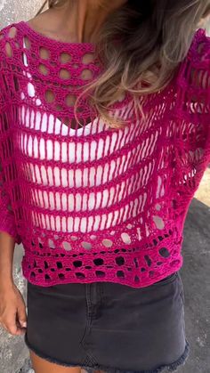 a woman wearing a pink crochet top