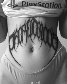 the back of a woman's stomach with an inscription tattoo design on it that reads,