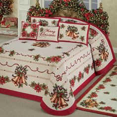 a christmas themed bed spread with bells and poinsettis on it's side