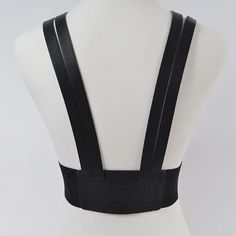 Introducing the Two Buckle Suspend Belt - a stylish and versatile accessory that effortlessly enhances any outfit. This sleek and chic belt is designed for the modern woman who seeks both functionality and fashion-forwardness. Crafted with meticulous attention to detail, this black leather harness with gold buckles is a true head-turner. * Polyurethane/ elastic. * Approx. Width:3" Length:33.5" Black Harness Belt, Black Strap Corset Belt For Party, Elegant Black Belts And Suspenders For Party, Black Corset Belt With Straps For Party, Adjustable Belt Harness For Party, Black Strapped Harness For Night Out, Modern Black Belts And Suspenders For Work, Black Strapped Corset Belt For Party, Elegant Black Corset Belt For Club