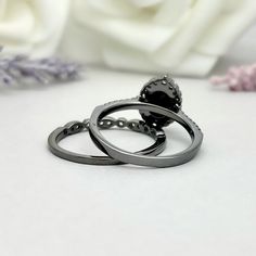 This beautiful ring is made from genuine 925 sterling silver with black rhodium plating. Engagement Ring details- -The Main stone is an oval cut 8mm by 6mm Natural Faceted Black Onyx Stone -Side stones are Round 1.2MM-2MM Simulated Diamonds Band Details- -2mm Face Height -Stones are 1.75mm and 1.4mm Simulated Diamonds -Ring is cast in solid 925 sterling silver with black rhodium plating (Rose gold, yellow gold and white rhodium plated also available, please check the drop down menu for more opti Black Round Halo Jewelry, Round Black Halo Jewelry, Black Anniversary Rings With Halo Detail, Gunmetal Elegant Rings For Gift, Black Halo Jewelry For Anniversary, Elegant Gunmetal Rings For Gift, Gunmetal Rings For Gift, Elegant Style, Black Oval Cubic Zirconia Rings, Gift Black Ring With Oxidized Finish