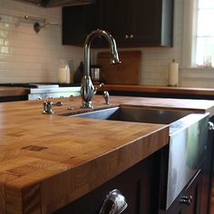 a kitchen counter top with a sink and faucet in the middle of it