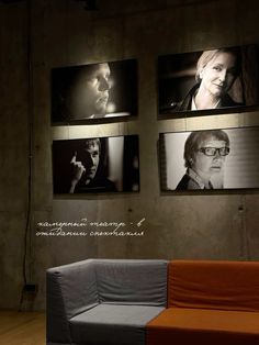 an orange couch sitting in front of three pictures on the wall and one with a man's face