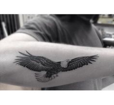 an eagle tattoo on the arm