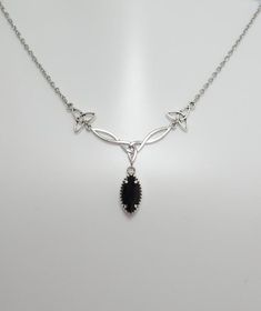 This is a new handmade necklace. It is made with antiqued silver plated Celtic knots, accented with a high quality JET BLACK ONYX glass jewel that sparkles like crystal. Decorated portion is 2 1/2" wide and 1 1/4" tall in the center. Necklace is adjustable 15-18" with a lobster clasp and chain extender. If you would like a different length, please send us a message.Matching earrings and headpiece are listed in our store in a variety of stone colors. If you don't see items with a color you want, Elegant Pewter Necklace As A Gift, Elegant Pewter Necklace As Gift, Elegant Pewter Necklace For Gift, Elegant Pewter Necklace In Antique Silver, Elegant Antique Silver Pewter Necklace, Elegant Silver Pewter Necklace, Gothic Silver Oval Necklace, Black Nickel-free Necklaces For Anniversary, Nickel-free Black Necklaces For Anniversary