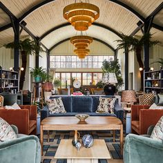 a living room filled with furniture and lots of windows