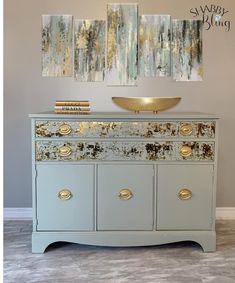 an old dresser has been painted with gold and silver paint