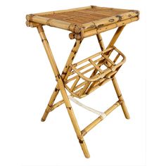 a small bamboo table with two folding chairs on the top and one holding a magazine rack