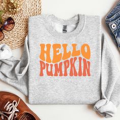 🎃🍁 Say Hello to Cozy Season! 🍁🎃 Embrace the fall vibes with our HELLO PUMPKIN sweatshirt, designed in a fun and wavy retro font that screams nostalgia! This super-soft, snuggle-worthy sweatshirt is your go-to for crisp autumn mornings, pumpkin spice lattes, and everything cozy. 🍂 😁Bring smiles to your world. 🍂 Retro-Inspired Design: The playful font adds a touch of vintage charm to your fall wardrobe! 🎃 Perfect Fall Colors: Pair it with your favorite jeans or leggings for an effortlessly Trendy Fall Sweater With Screen Print, Trendy Fall Sweatshirt With Screen Print, Trendy Graphic Print Sweatshirt For Fall, Trendy Fall Tops With Lettering, Casual Screen Print Sweatshirt For Fall, Casual Fall Sweatshirt With Screen Print, Trendy Fall Tops With Graphic, Trendy Tops With Lettering For Fall, Casual Sweatshirt With Screen Print For Fall