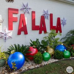 there is a sign that says falaa in front of some plants and flowers