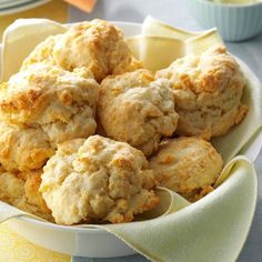 a bowl filled with biscuits on top of a table