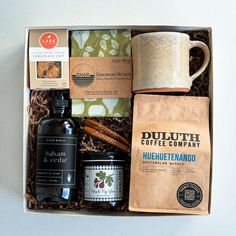 a box containing coffee, cinnamons, and other condiments is shown in this image