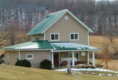 a house with a green roof in the country