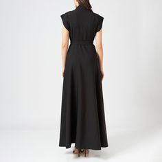 This bias-cut wrap dress is crafted from a soft fabric, falling elegantly to ankle length. The dress wraps around the body, cinching the waist with a matching tie belt, and is fitted at the bust and waist for a flattering, feminine silhouette.  The top of the dress features intricate hand embroidery, adding a delicate touch to the sleek design. It has a V-neckline, balancing the detailed embroidery with a minimalist, tailored look.  The bias cut allows the fabric to drape naturally over the body Elegant A-line Wrap Dress For Evening, Fitted Maxi Wrap Dress For Evening, Fitted Maxi Length Wrap Dress For Evening, Floor-length Evening Wrap Dress For Spring, Fitted Floor-length Wrap Dress For Evening, Floor-length Wrap Dress For Spring Evening, Linen Maxi Dress For Work, Elegant Long Fitted Wrap Dress, Spring Evening Floor-length Wrap Dress