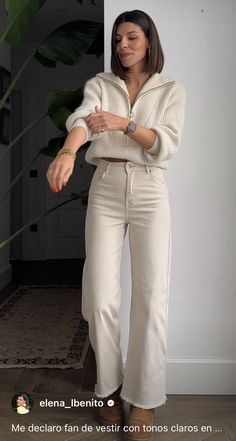 a woman standing in front of a plant